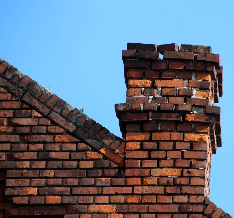 Damaged chimney on an Spokane home showing cracks and missing mortar